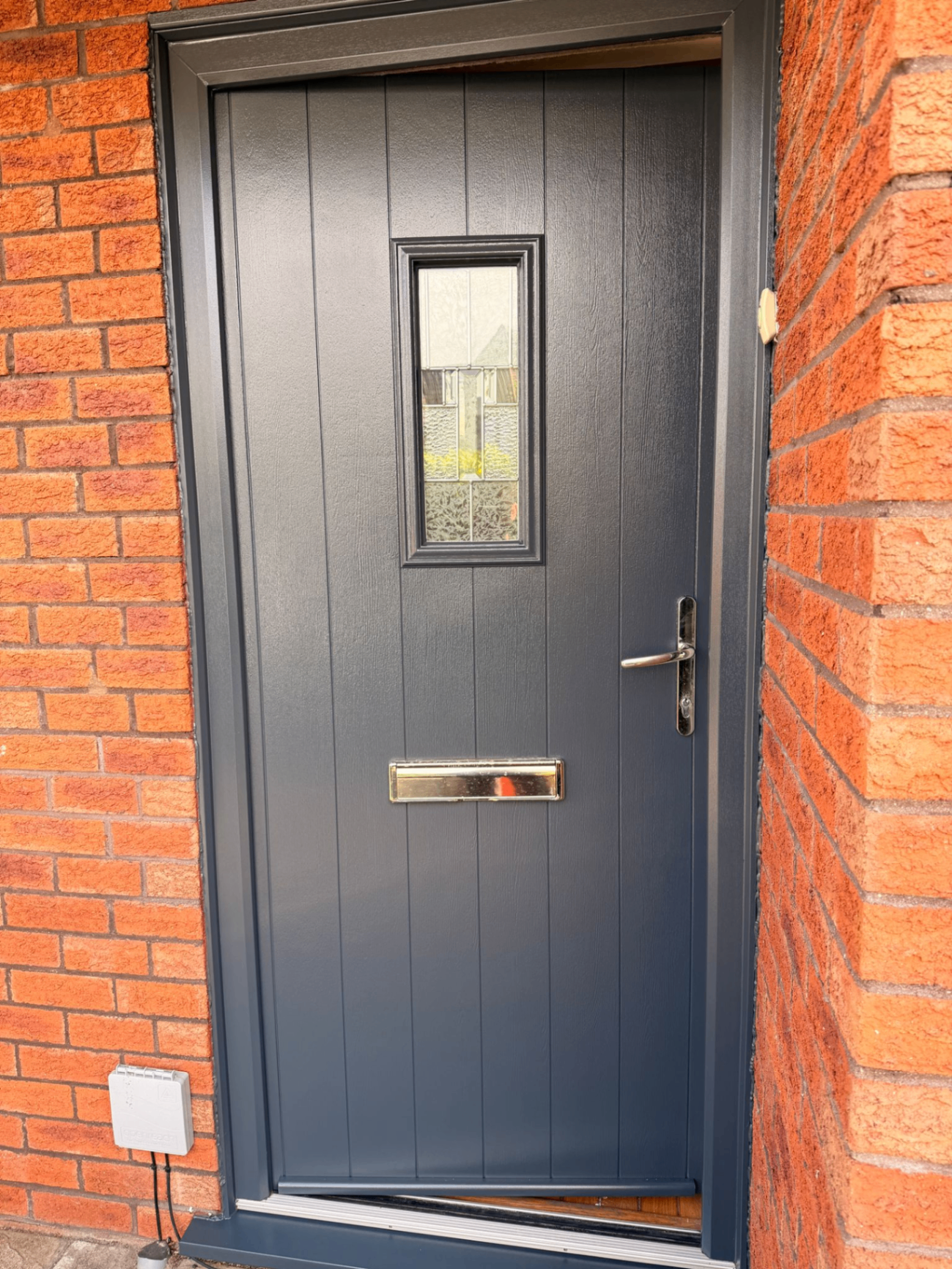 Anthracite composite front door respray on red brick